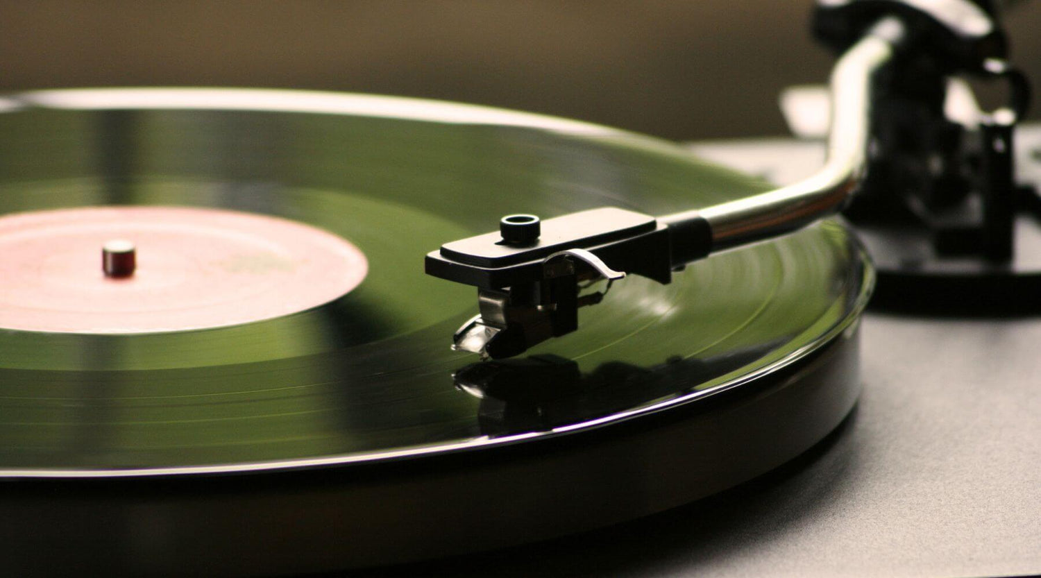 Close-up of a turntable with a vinyl record on a dark surface